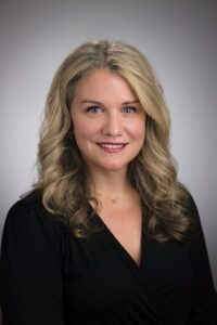 Businesswoman with blonde hair and black top